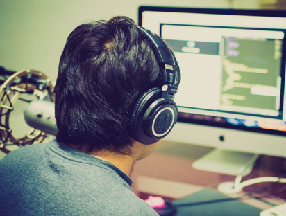 Man Wearing Headphones While Screening Music