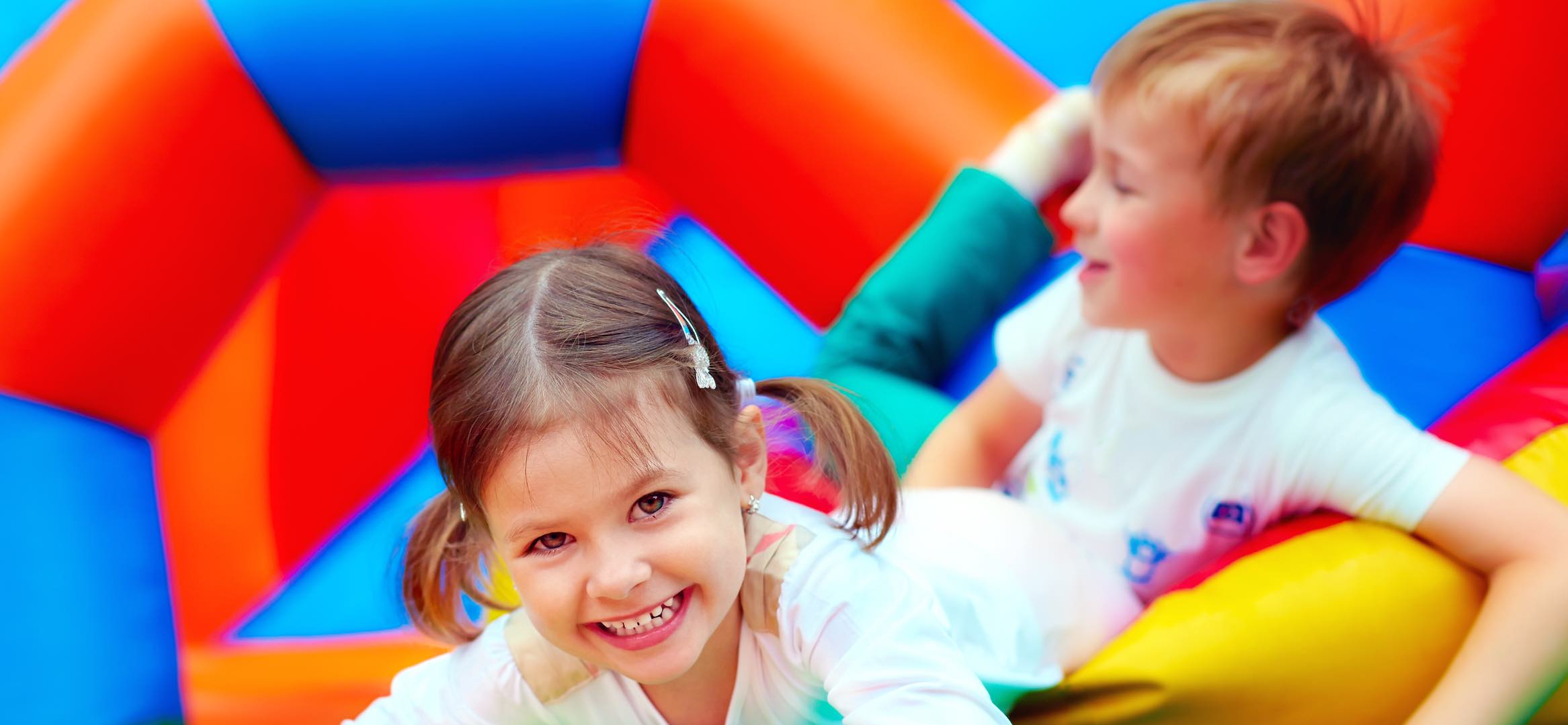 Two Children Jumping on an Inflatable